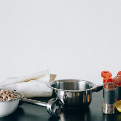 A flat lay of chickpeas, a pot, and spices ready for making hummus.