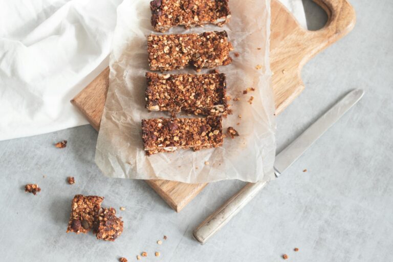 Delicious homemade granola bars on a wooden board, perfect for healthy snacking and meal preparation.